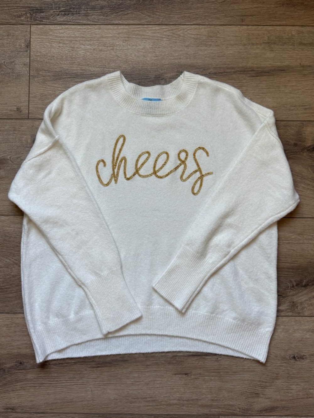 CeCe Cream Supersoft Crewneck Sweater with Gold Beaded 'cheers' Script